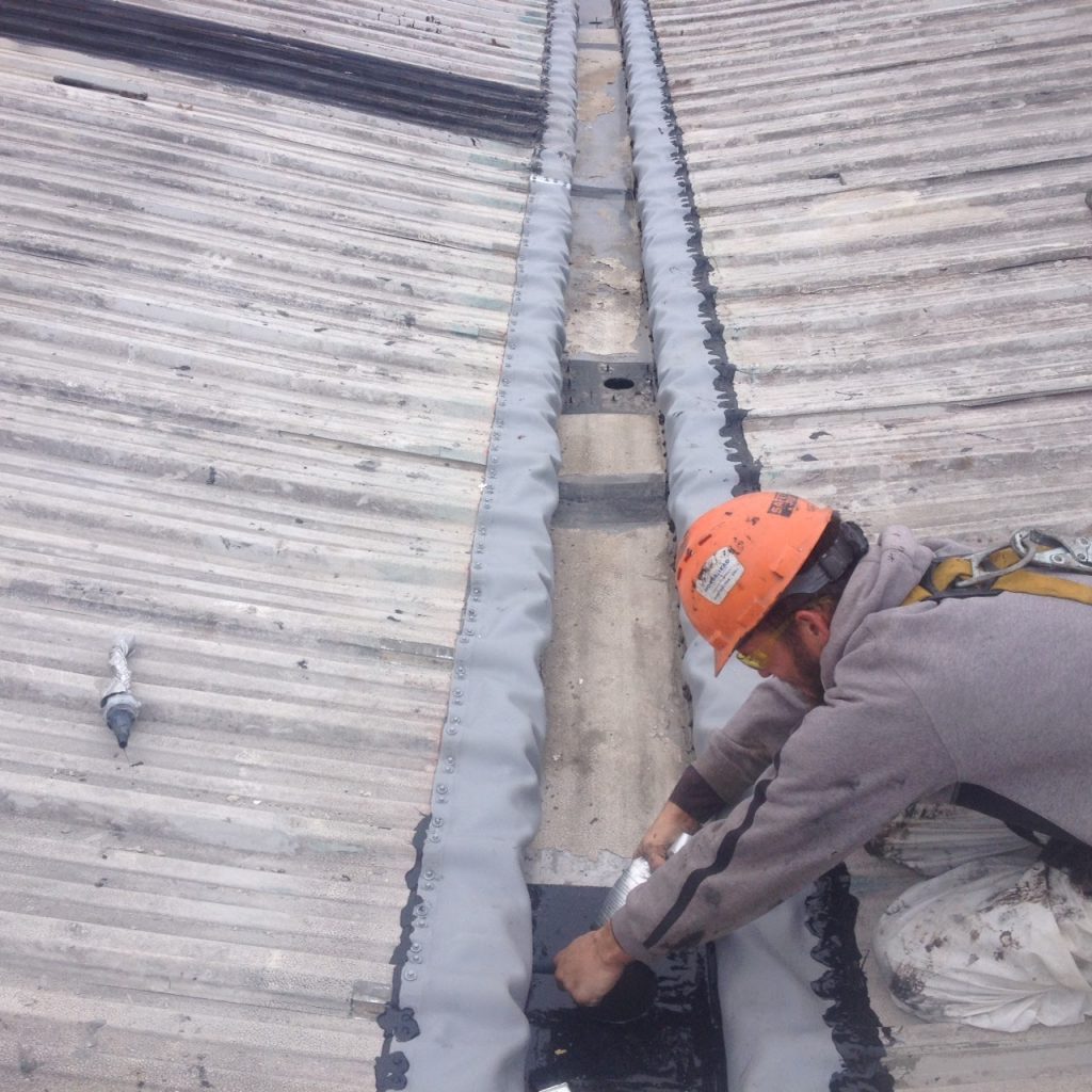 Commercial Roofer Repairing Internal Gutters